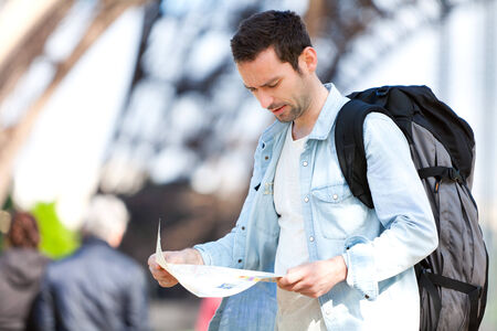 Young attractive tourist reading map in Paris, Franceの写真素材