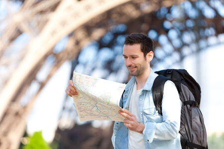 Young attractive tourist reading map in Paris, Franceの写真素材