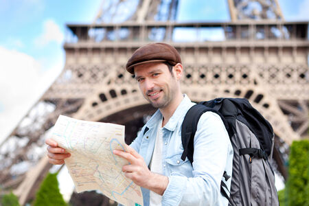 Young attractive tourist reading map in Paris, Franceの写真素材