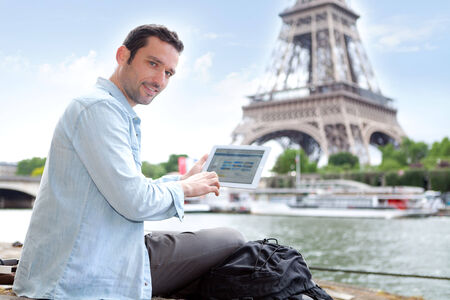 View of a Young attractive tourist using tablet in Paris, Franceの写真素材