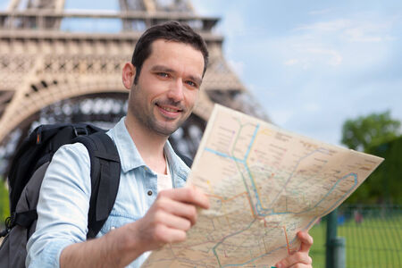 Young attractive tourist reading map in Paris, Franceの写真素材