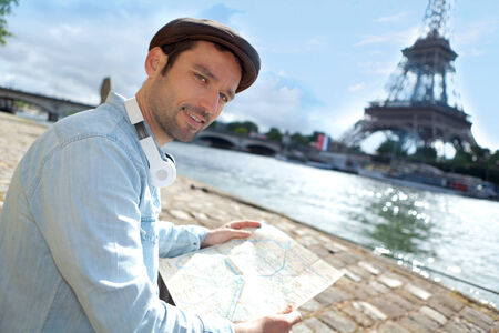 Young attractive tourist reading map in Paris, Franceの写真素材