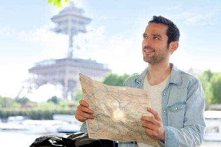 Young attractive tourist reading map in Paris, Franceの写真素材
