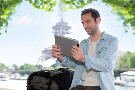 View of a Young attractive tourist using tablet in Paris, Franceの写真素材