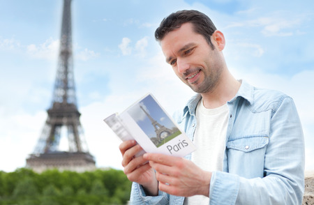 View of a Young attractive tourist reading a guide in Paris , Franceの写真素材