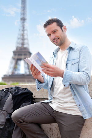 View of a Young attractive tourist reading a guide in Paris , Franceの写真素材