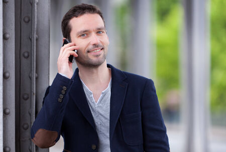 Young attractive man using smartphone in Paris, Franceの写真素材