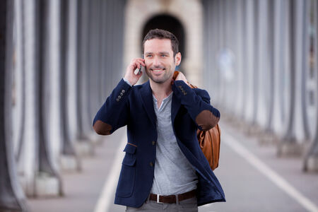 Young attractive man using smartphone in Paris, Franceの写真素材
