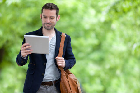 View of a Young attractive man using tablet in Paris, Franceの写真素材