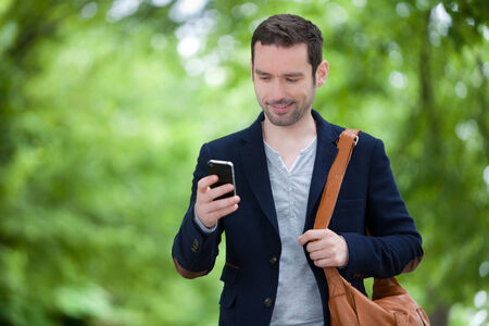 Young attractive man using smartphone in Paris, Franceの写真素材