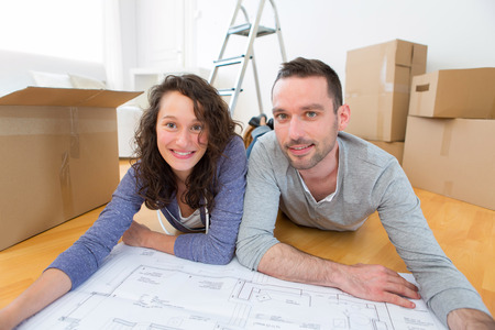 View of a Young couple watching plans in their new flatの写真素材