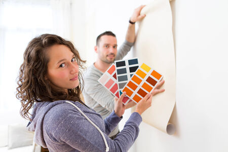View of a Young couple choosing colors of their wallpaperの写真素材