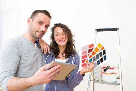 View of a Young couple choosing colors of their new flatの写真素材