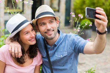 View of a Young couple on holidays taking selfieの写真素材