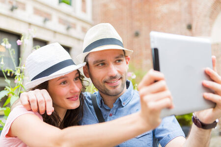 View of a Young couple on holidays taking selfieの写真素材