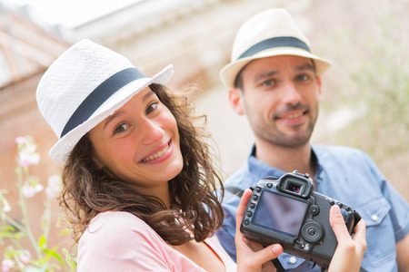 View of a Young couple of tourist watching photographsの写真素材
