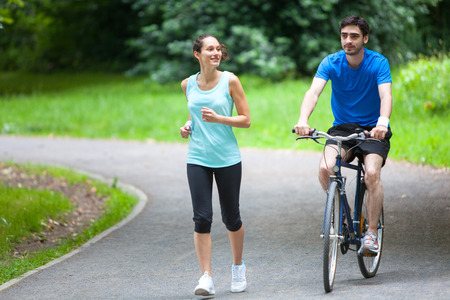 View of a Young sportive couple jogging at the parkの写真素材