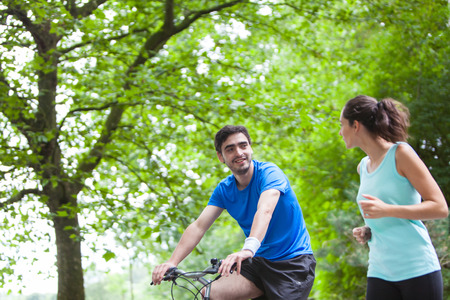 View of a Young sportive couple jogging at the parkの写真素材