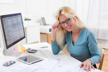 View of a Blonde architect watching blueprint at the officeの写真素材