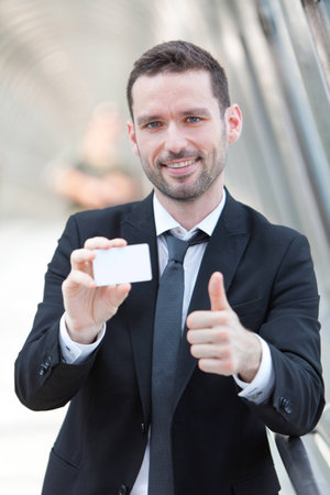 View of an Attractive businessman showing an empty textspace cardの写真素材