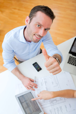 Real estate agent and customer at the officeの写真素材