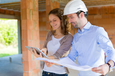 View of a Young woman and architect on construction site の写真素材