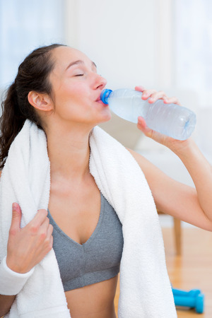 VIew of a Woman drinking water after a sport sessionの写真素材
