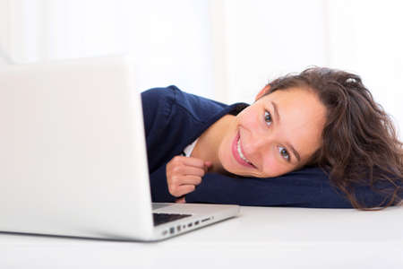 View of a young student in front of laptopの写真素材