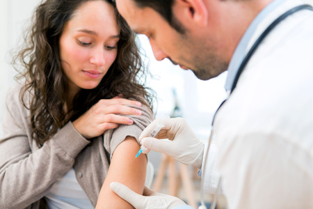 View of a Young attractive woman being vaccinatedの写真素材