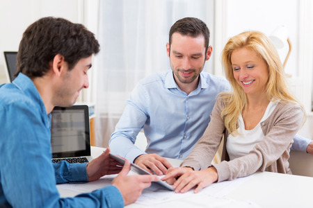 View of a Young attractive couple signing contract on tabletの写真素材