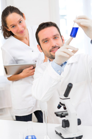 View of a Scientist and his assistant working in a laboratoryの写真素材