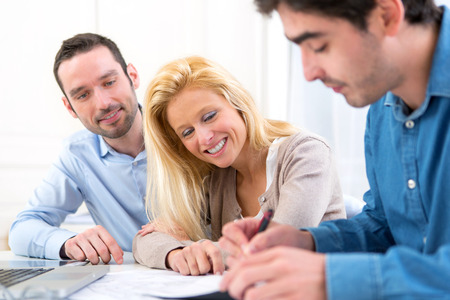 View of a young serious couple meeting a real estate agentの写真素材