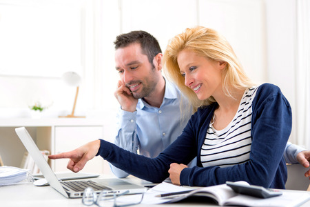 View of a Young attractive couple using laptop at homeの写真素材