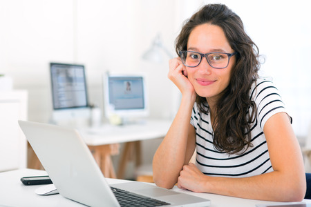 View of a Young attractive student woman working at homeの写真素材