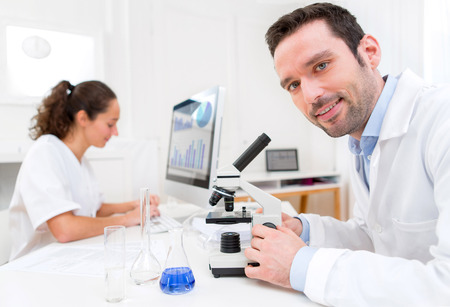 View of a Scientist and her assistant in a laboratoryの写真素材