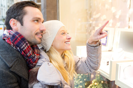 View of an Young attractive couple doing some window shoppingの写真素材