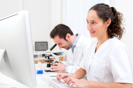 View of a Scientist and her assistant in a laboratoryの写真素材