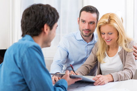 View of a Young attractive couple signing contractの写真素材
