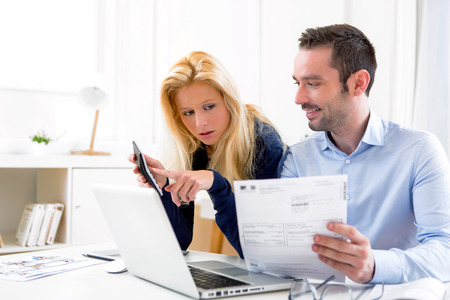 View of an Attractive couple doing administrative paperworkの写真素材