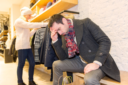 View of a Young casual man waiting while his wife's shoppingの写真素材