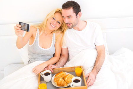 View of a Young attractive couple taking selfie during breakfastの写真素材