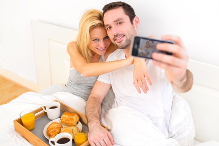 View of a Young attractive couple taking selfie during breakfastの写真素材