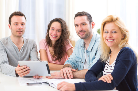 View of a Group of 4 young attractive people working on a laptopの写真素材
