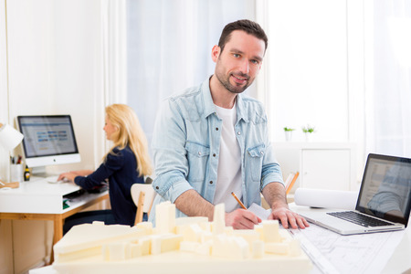 View of a Young attractive architect working at the office