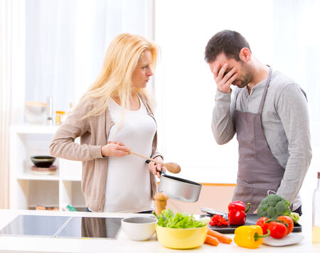 View of a Young attractive couple having an argue while cookingの写真素材