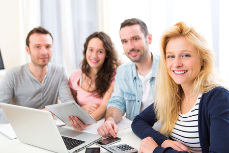 View of a Group of 4 young attractive people working on a laptopの写真素材