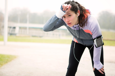 View of a Young attractive woman stretching after a running session