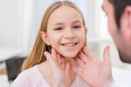 View of a Young little girl being examinated by a doctor