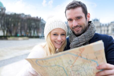 View of a Couple of young attractive tourists watching mapの写真素材