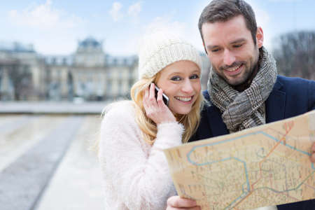 View of a Couple of young attractive tourists watching mapの写真素材